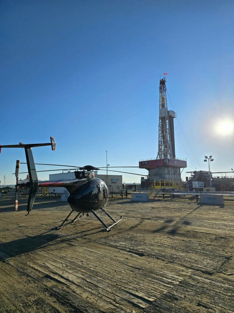 Helicopter with Drilling Rig and Sun